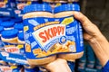 Shoppers hand holding a Twin Pack Plastic Jars of Skippy brand peanut butter