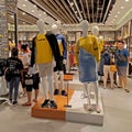 Shoppers and mannequins in the fashion store