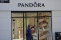 SHOPPERS PASS BY PANDORA STORE