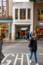 Shoppers passing through an entrance archway to Borough Market in London