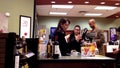 Shoppers paying wine inside liquor store