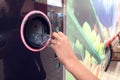 Shoppers return bottles and cans of reusable packagings in a reverse vending machine. Environmental protection concept