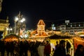 Shoppers and souvenir hunters enjoy an evening amongst the illuminated huts of the Birmingham Christmas market