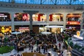 Shoppers visit the mall during winter at discount and sale season. Food court in AFI Cotroceni Shopping Mall in Bucharest, Romania Royalty Free Stock Photo