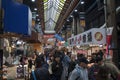 Shoppers visit Nipponbashi Kuromon Ichiba market in Osaka Japan Royalty Free Stock Photo