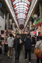 Shoppers visit Nipponbashi Kuromon Ichiba market in Osaka Japan Royalty Free Stock Photo