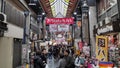 Shoppers visit Nipponbashi Kuromon Ichiba market in Osaka Japan Royalty Free Stock Photo