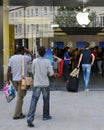 Shoppers walk to an Apple store in London Royalty Free Stock Photo