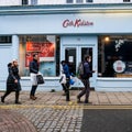 Shoppers Walking Past A Closed Cath Kidston Childrens Fashion Retailer