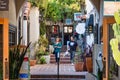 Shoppers walking in small alley with stores around