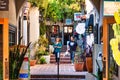 Shoppers walking in small alley with stores around