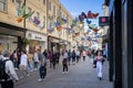 Shoppers walking under a canopy of brightly coloured butterflies in Southgate Shopping Centre in Bath, Avon, UK