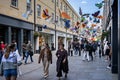 Shoppers walking under a canopy of brightly coloured butterflies in Southgate Shopping Centre in Bath, Avon, UK