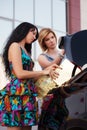 Fashion women with shopping bags on a car parking