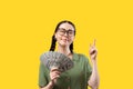 Shopping and advertising. Portrait of a smiling attractive Caucasian woman wearing eyeglasses holding a fan of dollar Royalty Free Stock Photo