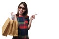 Shopping asian woman wearing sunglasses holding bags and pointing at copy space isolated on white background with clipping path Royalty Free Stock Photo