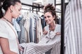 Pleasant shopping assistant recommending nice dress her constant visitor