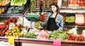 shopping assistant weighing fruit and vegetables in grocery shop Royalty Free Stock Photo