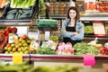 shopping assistant weighing fruit and vegetables in grocery shop Royalty Free Stock Photo