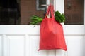 Shopping bag with goods and food is hanging at the front door, neighborhood help concept at quarantine time because of coronavirus