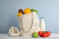 Shopping bag with fresh vegetables and other products on white wooden table Royalty Free Stock Photo