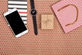 shopping bag, gift box, notepad, watch and smart phone on craft paper background in red polka dots Royalty Free Stock Photo