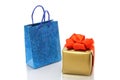 Shopping bag and gold present Royalty Free Stock Photo