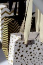 Shopping bags, gift boxes in sunlight on white background. Golden stars, black geometric lines- fashion modern design