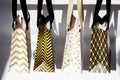 Shopping bags, gift boxes in sunlight on white background. Golden stars, black geometric lines- fashion modern design