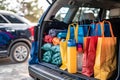 Shopping bags and supplies needs in family car trunk at a shopping mall parking Royalty Free Stock Photo