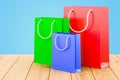 Shopping bags on the wooden table, 3D Royalty Free Stock Photo