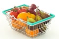 Shopping basked with fruits and vegetables on a white background