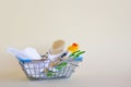 Shopping basket with baby care items - scissors, two hairbrushes, thermometer, cotton pads and nasal aspirator. Royalty Free Stock Photo