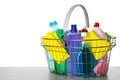 Shopping basket with different detergents on grey table