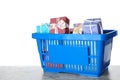 Shopping basket full of gift boxes on marble table against background Royalty Free Stock Photo