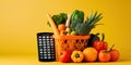 A shopping basket full of groceries with a calculator next to it, symbolizing budget grocery shopping, concept of Royalty Free Stock Photo