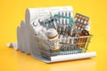 Shopping basket full of medicines, pills, blisters and vaccine on a receipt. Expensive medicine and healthcare concept