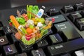 Shopping basket full of products on computer keyboard concept, Online food ordering concept. 3D rendering Royalty Free Stock Photo