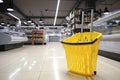 Shopping basket in interior of modern grocery store