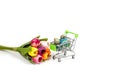 Shopping basket with painted Easter eggs and a bouquet of tulips isolated Royalty Free Stock Photo