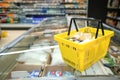 Shopping basket on refrigerator of modern grocery store