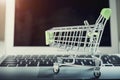 Shopping basket on top of laptop with free copy space. Online shopping and payment concept. E-commerce and global network business Royalty Free Stock Photo