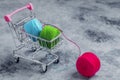 Shopping basket on wheels.The colored threads are red, green and blue Royalty Free Stock Photo