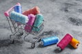 Shopping basket on wheels. Colored threads are red  yellow Royalty Free Stock Photo