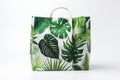 Shopping or Beach bag with green tropical leaf print on white background, front view Royalty Free Stock Photo