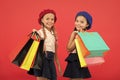 Shopping become fun with best friends. Kids cute schoolgirls hold bunch shopping bags. Children satisfied by shopping