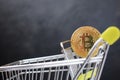 Shopping cart and bitcoin. Concept of cryptocurrency market Royalty Free Stock Photo