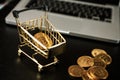 Shopping cart with bitcoin on laptop