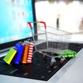 Shopping cart with cardboard boxes on laptop. 3d Royalty Free Stock Photo