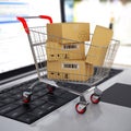 Shopping cart with cardboard boxes on laptop. 3d Royalty Free Stock Photo